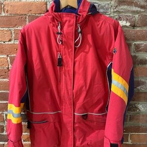 Red Hooded Obermeyer Jacket with Yellow and Blue Accents